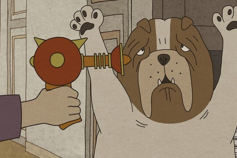 Un chien lève les pattes en l'air devant un pistolet jouet pointé sur lui.